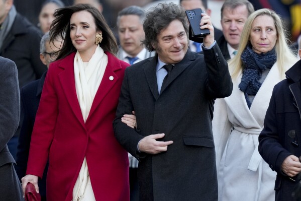 FILE - Argentine President Javier Milei walks arm-in-arm with Vice President Victoria Villarruel during Independence Day celebrations, in Buenos Aires, Argentina, July 9, 2024. Argentina's consumer price index report released Friday, July 12, 2024, showed Argentina’s annual inflation slowing a bit to just over 271% — still among the highest rates in the world. (AP Photo/Natacha Pisarenko, File)