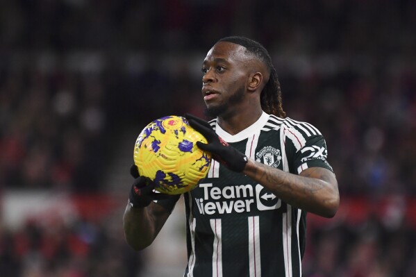 FILE -Manchester United's Aaron Wan-Bissaka holds the ball during the English Premier League soccer match between Nottingham Forest and Manchester United at City Ground in Nottingham, England, Saturday, Dec. 30, 2023. (AP Photo/Rui Vieira, File)