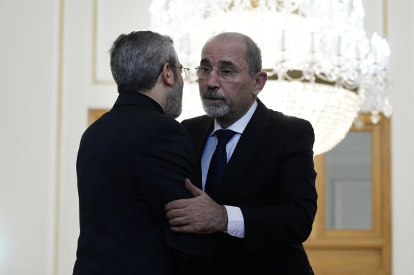 Jordan's Foreign Minister Ayman Safadi, right, is welcomed by Iran's acting Foreign Minister Ali Bagheri Kani, for their meeting in Tehran, Iran, Sunday, Aug. 4, 2024. (AP Photo/Vahid Salemi)