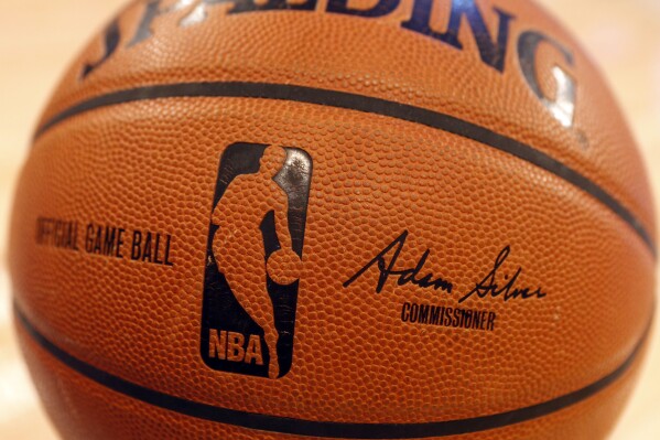 FILE - An NBA logo is seen on an official game ball before a basketball game, Feb. 1, 2014, in New York. The NBA said Wednesday, July 24, 2024 that it is not accepting Warner Bros. Discovery's $1.8 billion per year offer to continue its longtime relationship with the league and therefore has entered into a deal with Amazon Prime Video, a move that would mean this coming season would end a nearly four-decade run of games being on TNT. (AP Photo/Jason DeCrow, file)