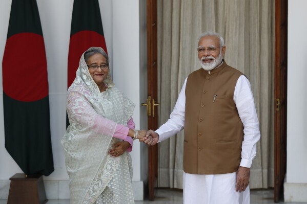 FILE- Indian Prime Minister Narendra Modi shakes hand with his Bangladeshi counterpart Sheikh Hasina before their meeting in New Delhi, India, Saturday, Oct. 5, 2019. (AP Photo/Manish Swarup, File)