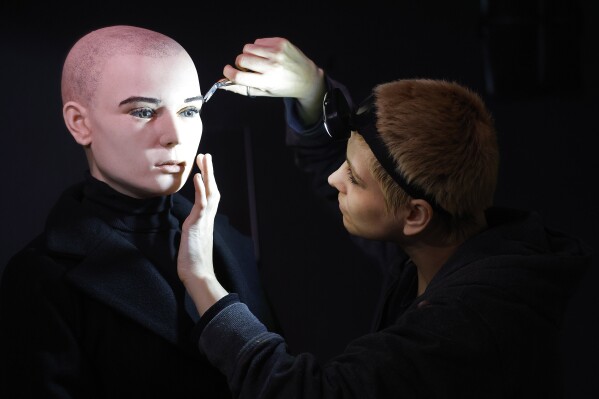 In this undated handout photo provided by The National Wax Museum Plus, Artistic Coordinator Mel Creek applies the finishing touches on a wax figure of the late singer Sinead O'Connor, at the National Wax Museum Plus on Dublin's Westmorland Street, Ireland. A wax figure of Sinéad O’Connor that did not compare to how the late singer looked caused a minor meltdown among fans and family members, leading a Dublin museum on Friday, July 26, 2024, to pull it from its collection. The National Wax Museum Plus apologized to O'Connor's family and said it would aim to create a more accurate representation of the singer of “Nothing Compares 2 U.” (Julien Behal via AP)