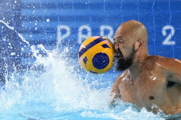 Japan's Katsuyuki Tanamura reaches for a shot during a Japan men's water polo team training session at the Olympic Aquatics Centre, ahead of the 2024 Summer Olympics, Tuesday, July 23, 2024, in Saint-Denis, France. (AP Photo/Luca Bruno)