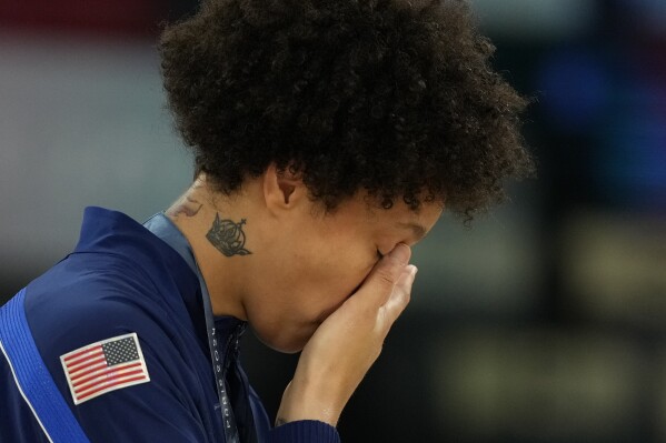 United States' Brittney Griner wipes a tear after a women's gold medal basketball game at Bercy Arena at the 2024 Summer Olympics, Sunday, Aug. 11, 2024, in Paris, France. (AP Photo/Mark J. Terrill)