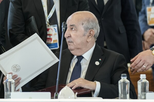 FILE - Algerian President Abdelmadjid Tebboune sits during a working session on AI, Energy, Africa and Mideast, at the G7, on June 14, 2024, in Borgo Egnazia, near Bari, southern Italy. Eleven prominent Algerian opposition figures wrote an open letter this week, denouncing “the authoritarian climate” surrounding the country’s upcoming presidential election and calling for a broad democratic transition. Under the rule of military-backed President Abdelmadjid Tebboune, freedom of expression has witnessed a rollback, experts say, with journalists and opposition members facing prison time and critical media outlets losing state advertising funding they have relied on to stay afloat.(AP Photo/Alex Brandon)