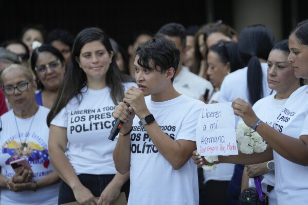 A family member of a protestor detained amid a government crackdown speaks during a vigil in Caracas, Venezuela, Thursday, Aug. 8, 2024. (AP Photo/Matias Delacroix)