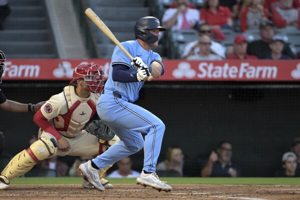 Toronto Blue Jays' Will Wagner, right, hits an RBI single during the third inning of a baseball game against the Los Angeles Angels, Monday, Aug. 12, 2024, in Anaheim, Calif. (AP Photo/Jayne-Kamin-Oncea)