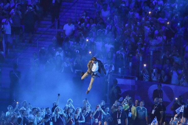 Tom Cruise is lowered into the stadium during the 2024 Summer Olympics closing ceremony at the Stade de France, Sunday, Aug. 11, 2024, in Saint-Denis, France. (AP Photo/Martin Meissner)