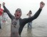 FILE- With his right eye swollen shut from the swim, Jim Dreyer emerges victorious from the water, Aug. 3, 1998, after completing a 43.2-mile, 41-hour crossing of Lake Michigan. (Jon M. Brouwer/The Grand Rapids Press via AP, File)