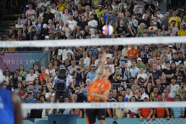 Spectators boo Netherland's Steven van de Velde as he serves to Brazil in a beach volleyball match at the 2024 Summer Olympics, Sunday, Aug. 4, 2024, in Paris, France. (AP Photo/Robert F. Bukaty)