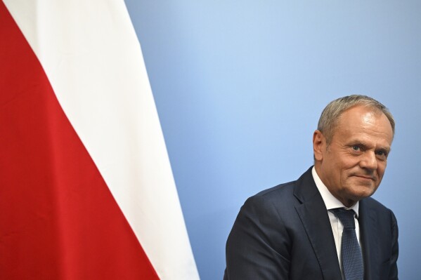 Poland's Prime Minister Donald Tusk reacts during a bilateral meeting with Britain's Prime Minister Keir Starmer, at the European Political Community meeting, at Blenheim Palace in Woodstock, southern England, Thursday July 18, 2024. (Justin Tallis/Pool Photo via AP)