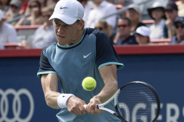 Italy's Jannik Sinner returns a shot to Croatia's Borna Coric during their second-round match at the National Bank Open tennis tournament Thursday, Aug. 8, 2024, in Montreal. (Ryan Remiorz/The Canadian Press via AP)