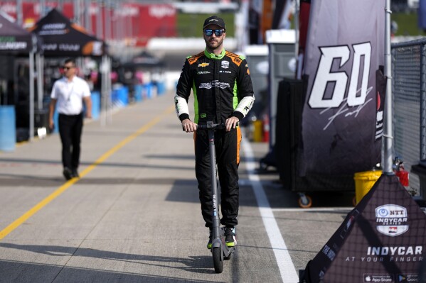 Agustin Canapino rides his scooter before an IndyCar auto race, Sunday, July 14, 2024, at Iowa Speedway in Newton, Iowa. (AP Photo/Charlie Neibergall)