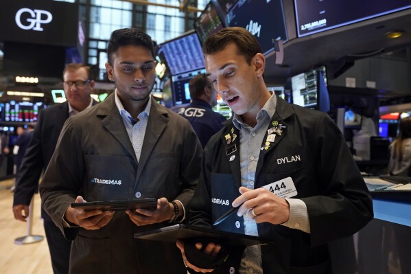 A pair of traders work on the floor of the New York Stock Exchange, Tuesday, Aug. 6, 2024.(AP Photo/Richard Drew)