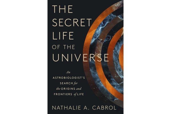 This cover image released by Scribner shows "The Secret Life of the Universe: An Astrobiologist's Search for the Origins and Frontiers of Life" by Nathalie A. Cabrol. (Scribner via AP)