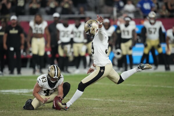 New Orleans Saints place kicker Charlie Smyth kicks the game winning field goal as Matthew Hayball (43) holds, in the second half of a preseason NFL football game against the Arizona Cardinals, Saturday, Aug. 10, 2024, in Glendale, Ariz. The Saints won 16-14. (AP Photo/Ross D. Franklin)