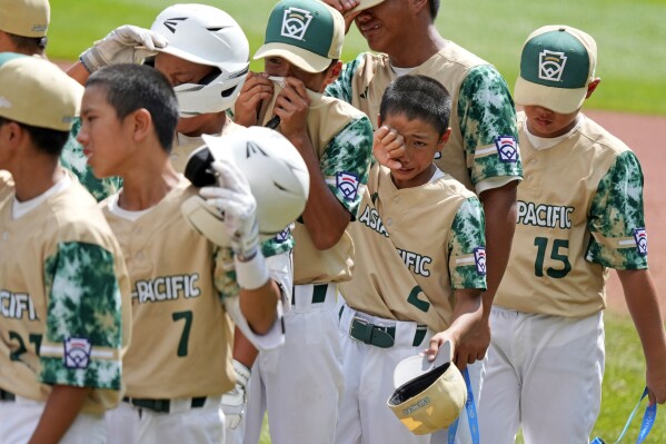 FILE - The Taiwan Little League team lines up for the handshake line after a 2-0 loss to Curacao in the International Championship baseball game at the Little League World Series tournament in South Williamsport, Pa., Saturday, Aug. 26, 2023. (AP Photo/Gene J. Puskar, File)