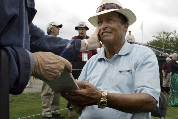 FILE - Chi Chi Rodriguez, of Puerto Rico, smiles while signing an autograph at the Nashawtuc Country Club in Concord, Mass., Friday, June 9, 2006. (AP Photo/Steven Senne, File)