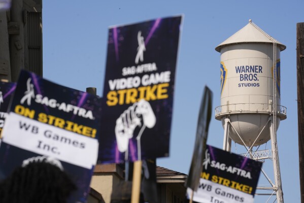 Picket signs in a kick-off picket line for the SAG-AFTRA video game strike at Warner Bros. Games headquarters on Thursday, Aug. 1, 2024, in Burbank, Calif. Hollywood's video game performers are currently on strike, throwing part of the entertainment industry into another work stoppage after talks for a new contract with major game studios broke down over artificial intelligence protections. (AP Photo/Chris Pizzello)