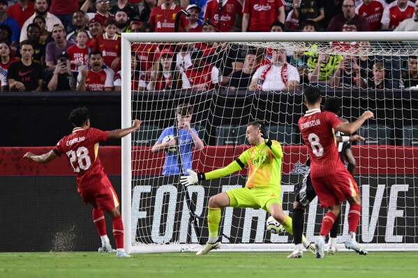 Liverpool's Fabio Carvalho (28) scores a goal past Arsenal goalkeeper Karl Hein, center, during the first half of an international friendly soccer match, Wednesday, July 31, 2024, in Philadelphia. (AP Photo/Derik Hamilton)