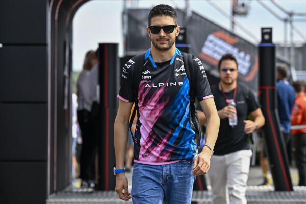 Alpine driver Esteban Ocon of France arrives in the paddock before of the third free practice ahead of Sunday's Formula One Hungarian Grand Prix auto race, at the Hungaroring racetrack in Mogyorod, near Budapest, Hungary, Saturday, July 20, 2024. (AP Photo/Denes Erdos)