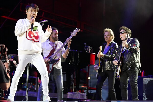 FILE - Arnel Pineda, Marco Mendoza, Jonathan Cain, and Neal Schon, of the band Journey, perform at Lollapalooza, July 31, 2021, at Grant Park in Chicago. (Photo by Rob Grabowski/Invision/AP, File)