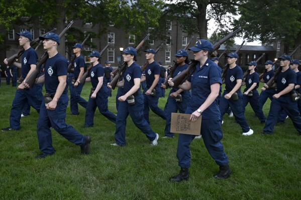 Swabs march under the eye of second class cadets known as cadre at the U.S. Coast Guard Academy, Monday, July 15, 2024, in New London, Conn. (AP Photo/Jessica Hill)