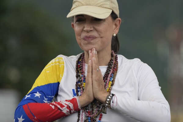 Opposition leader Maria Corina Machado greets supporters at a campaign rally for presidential candidate Edmundo Gonzalez, in Valencia, Venezuela, Saturday, July 13, 2024. (AP Photo/Ariana Cubillos)