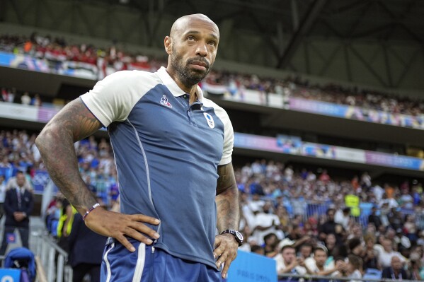 France's head coach Thierry Henry looks on prior to the men's semifinal soccer match between France and Egypt, at Lyon Stadium, during the 2024 Summer Olympics, Monday, Aug. 5, 2024, in Decines, France. (AP Photo/Laurent Cipriani)