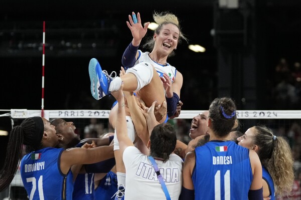 Monica de Gennaro of Italy is thrown in the air by her team after winning a gold medal women's volleyball match between the United States of America and Italy at the 2024 Summer Olympics, Sunday, Aug. 11, 2024, in Paris, France. (AP Photo/Alessandra Tarantino)