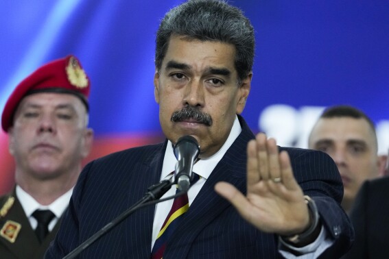 Venezuelan President Nicolas Maduro speaks to the press before leaving the Supreme Court where he arrived for procedures related to the court's audit of presidential election results in Caracas, Venezuela, Friday, Aug. 9, 2024. (AP Photo/Matías Delacroix)