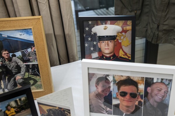 Photographs of Marine Corporal Spencer R. Collart and his fellow marines, Marine Corps Captain Eleanor V. LeBeau, bottom left, and Marine Corps Major Tobin J. Lewis, bottom right, are seen at the home of his parents in Arlington, Va., Thursday, June 19, 2024. Collart, 21, was killed along with the two Marines when the MV-22B Osprey aircraft they were on crashed during drills on a north Australian island on Aug. 27, 2023. (AP Photo/Rod Lamkey, Jr.)