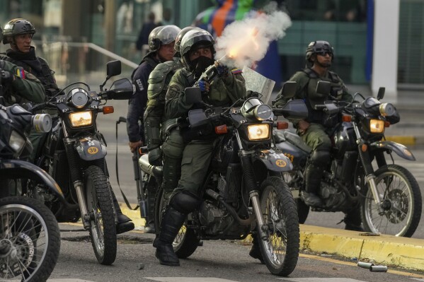 Police fire tear gas at protesters demonstrating against the official election results declaring President Nicolas Maduro's reelection, the day after the vote in Caracas, Venezuela, Monday, July 29, 2024. (AP Photo/Fernando Vergara)