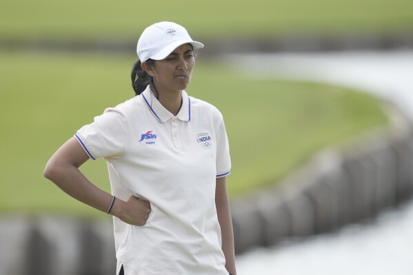 Aditi Ashok, of India, reacts after a double bogey on the 18th green during the first round of the women's golf event at the 2024 Summer Olympics, Wednesday, Aug. 7, 2024, at Le Golf National, in Saint-Quentin-en-Yvelines, France. (AP Photo/Matt York)