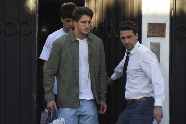 French rugby players Oscar Jegou, center, and Hugo Auradou, back, are released from house arrest, pending trial in Mendoza, Argentina, Monday, Aug. 12, 2024. The players were arrested following charges of sexual assault after France played Argentina in Mendoza on July 6. (AP Photo/Mariana Villa)