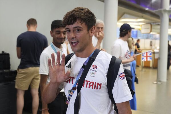 Great Britain's Tom Daley arrives by Eurostar into London St. Pancras International train station after competing at the 2024 Paris Olympic Games in France, Monday Aug. 12, 2024. Five-time Olympic gold medalist Tom Daley has announced his retirement from diving. (Jordan Pettitt/PA via AP)