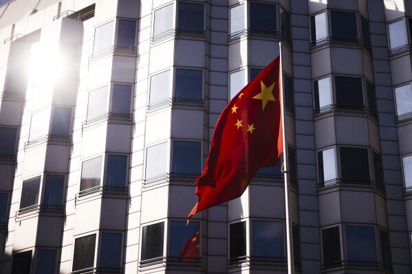 FILE - The Chinese national frag waves in front of the country's embassy in Berlin, Tuesday, April 23, 2024. Officials in Berlin say an investigation has determined that “Chinese state actors” were responsible for a 2021 cyberattack on Germany’s national office for cartography. (AP Photo/Markus Schreiber, File)