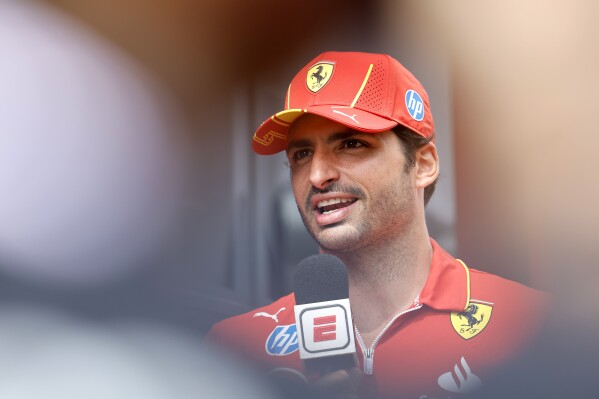 FILE - Ferrari driver Carlos Sainz of Spain speaks with the media ahead of the Formula One Grand Prix at the Spa-Francorchamps racetrack in Spa, Belgium, Thursday, July 25, 2024. (AP Photo/Geert Vanden Wijngaert, File)