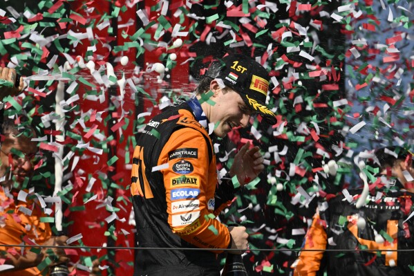 McLaren driver Oscar Piastri of Australia celebrates on the podium after winning the Hungarian Formula One Grand Prix race at the Hungaroring racetrack in Mogyorod, Hungary, Sunday, July 21, 2024. (AP Photo/Denes Erdos)