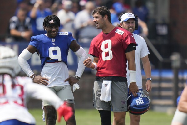 New York Giants quarterback Daniel Jones, right, talks with Malik Nabers during the NFL football team's training camp in East Rutherford, N.J., Sunday, July 28, 2024. (AP Photo/Seth Wenig)