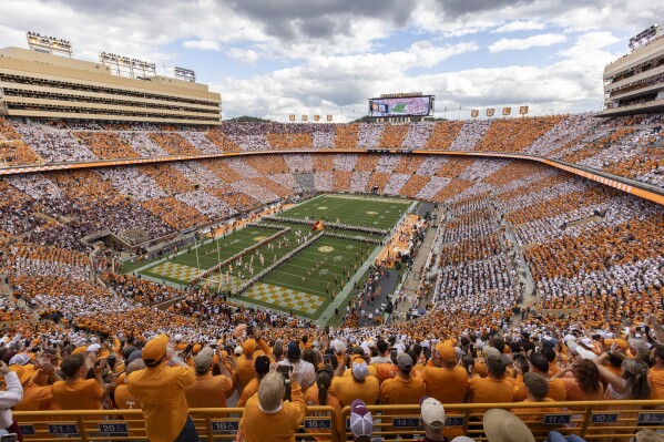 FILE - Tennessee players run onto the field at Neyland Stadium before an NCAA college football game between Tennessee and Texas A&M Saturday, Oct. 14, 2023, in Knoxville, Tenn. (AP Photo/Wade Payne, File)