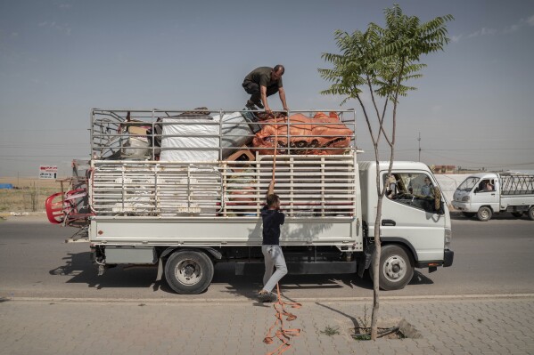 Yazidis in Khanke in the Duhok area of the Kurdistan region of Iraq, prepare to return to their homes in Sinjar, Monday, June 24, 2024. (AP Photo/Julia Zimmermann)