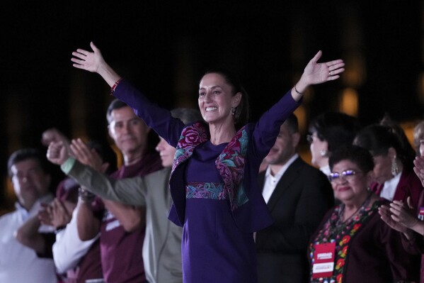 Future President Claudia Sheinbaum waves to supporters at the Zocalo, Mexico City's main square, after the National Electoral Institute announced she held an irreversible lead in the election, early Monday, June 3, 2024. (AP Photo/Marco Ugarte)