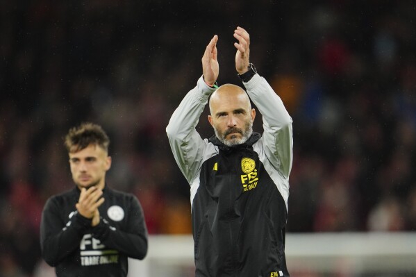 FILE - Leicester's head coach Enzo Maresca applauds fans at the end of the English League Cup third round soccer match between Liverpool and Leicester City at the Anfield stadium in Liverpool, England, on Sept. 27, 2023. A quarter of the coaches will be taking charge of a Premier League game for the first time, with Liverpool (Arne Slot), Chelsea (Enzo Maresca) and Brighton (Fabian Hurzeler) all having new managers and both Southampton (Russell Martin) and Ipswich (Kieran McKenna) gaining promotion with managers owning no top-flight experience. (AP Photo/Jon Super, File)