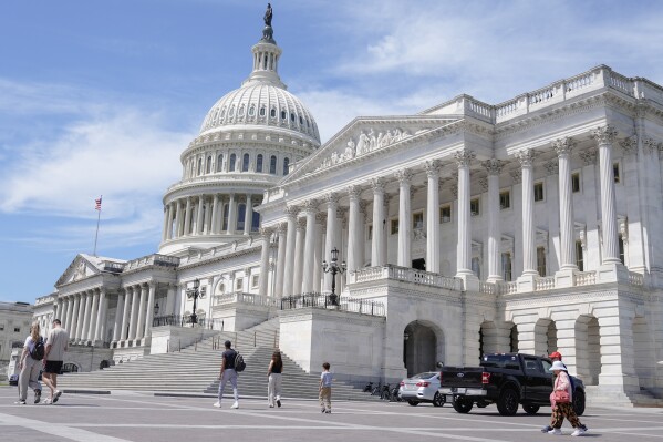 Visitors walk outside of the U.S Capitol Thursday, June 20, 2024, in Washington. (AP Photo/Mariam Zuhaib)