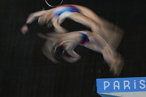 France's Jade Gillet and Emily Hallifax warms up prior to the women's synchronised 10m platform diving final at the 2024 Summer Olympics, Wednesday, July 31, 2024, in Saint-Denis, France. (AP Photo/Jin Lee Man)