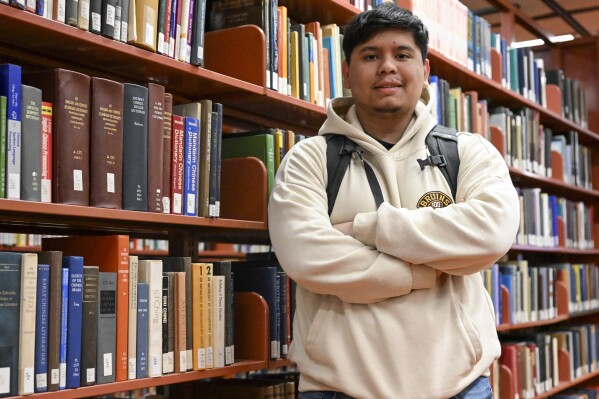 Jesus Noyola, a sophomore attending Rensselaer Polytechnic Institute, poses for a portrait in the Folsom Library, Tuesday, Feb. 13, 2024, in Troy, N.Y. A later-than-expected rollout of a revised Free Application for Federal Student Aid, or FASFA, that schools use to compute financial aid, is resulting in students and their parents putting off college decisions. Noyola said he hasn’t been able to submit his FAFSA because of an error in the parent portion of the application. “It’s disappointing and so stressful since all these issues are taking forever to be resolved,” said Noyola, who receives grants and work-study to fund his education. (AP Photo/Hans Pennink)