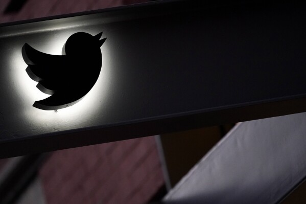 FILE - The Twitter logo is seen on the awning of the building that houses the Twitter office in New York, on Oct. 26, 2022. The European Union says blue checkmarks from Elon Musk’s X are deceptive and that the online platform falls short on transparency and accountability requirements. (AP Photo/Mary Altaffer, File)