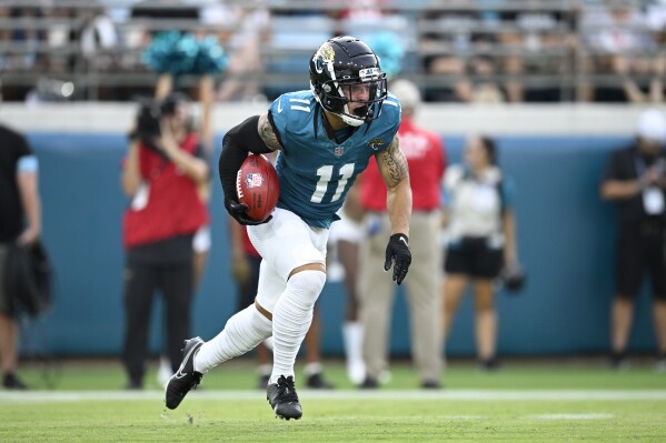 Jacksonville Jaguars wide receiver Parker Washington (11) returns a kickoff during the first half of a preseason NFL football game against the Kansas City Chiefs, Saturday, Aug. 10, 2024, in Jacksonville, Fla. (AP Photo/Phelan M. Ebenhack)