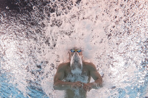 Tomoru Honda, of Japan, competes during a heat in the men's 200-meter butterfly at the 2024 Summer Olympics, Tuesday, July 30, 2024, in Nanterre, France. (AP Photo/David J. Phillip)